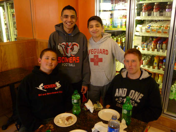 Gio Tideto (back right) talks college basketball with his friends from Somers Middle School Tuesday. 