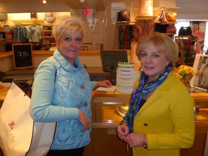 Talbots Sales Associate Cindy Minisci, right, tells customer Jill Notarpole, left, about their 35th anniversary celebration April 5. 