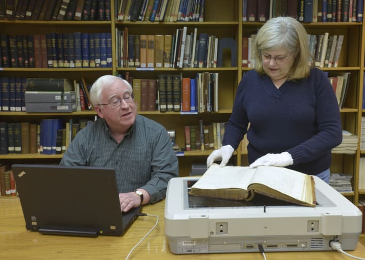 WCSU Adjunct Librarian Roseanne Shea and her husband, Gerald, help scan more than 2,600 pages of 19th century documents available at WCSU in Danbury.