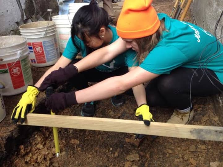 Dobbs Ferry&#x27;s Midori Kihara. left, helps rebuild a home for a Pennsylvania during her spring break from Providence College.