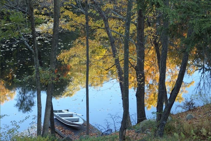Fall reflections on the lake and dock below