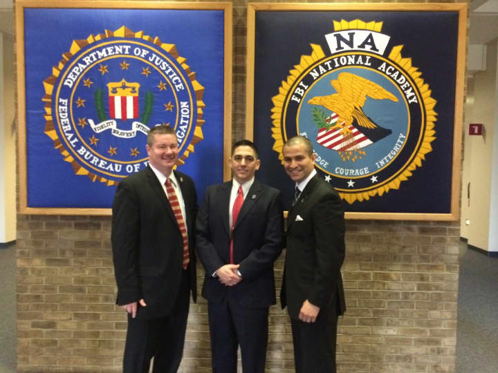 Bedford Police Chief William Hayes, left  and Lt. Melvin Padilla, right, congratulate Sgt. Andrew Bellantone, center at the FBI National Academy in Quantico, Va.
