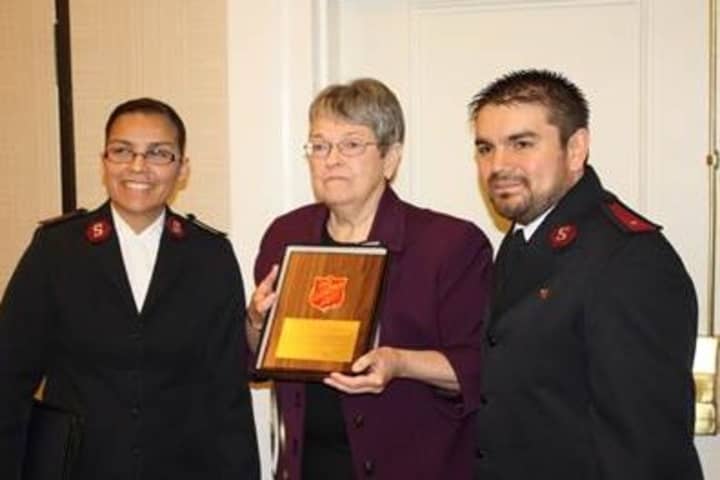 HPCW Executive Director Mary Spengler; (center) receives a plaque from Salvation Army representatives Lorena Castillo, left, and Alexis Castillo.
