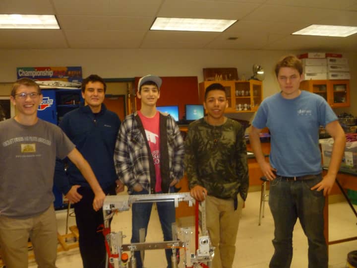 Members of the Ossining High School Robotics Club pose with their robot.