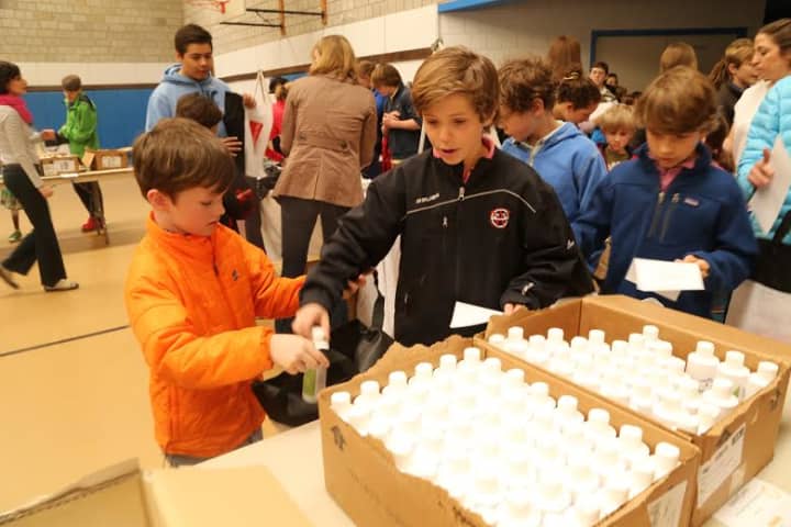 New Canaan Country School students worked together in buddies to assemble emergency kits for AmeriCares as part of an ongoing service learning partnership.