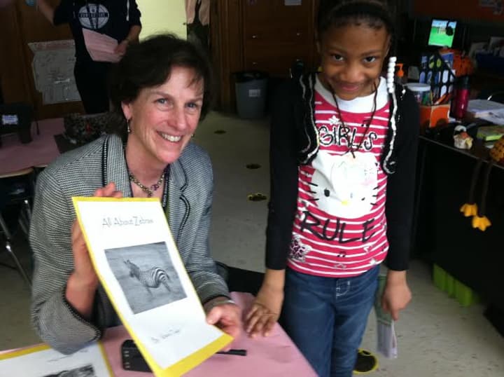 Springdale Elementary School principal Anne Downey and first-grader Kitana Taylor show off one of the displays at the Stamford schools Creature Creation Museum. 