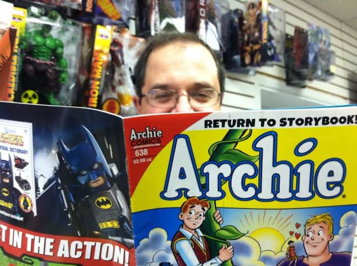 A Timeless Journey owner Paul Salerno checks out an Archie comic at his Stamford comic book store business. The adult Archie in the series &quot;Life With Archie,&quot; will be killed off in July.