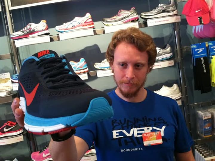 Trevor Nelson, 24, of Fleet Feet Sports in Stamford holds a Nike shoe. He said it was difficult to talk about the Boston Marathon bombing after it happened.