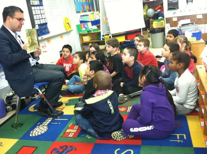 Vinnie Fusco, GM and executive in Charge of Production at NBCUniversal&#x27;s Stamford Media Center, reads to Grade 1 students at Toquam Magnet School on Tuesday.