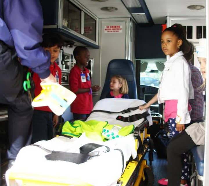 Greenwich Emergency Medical Services show children the inside of an ambulance and how to work a stretcher. A community fundraiser honoring EMS units from Harrison, Port Chester-Rye Brook and Greenwich is planned at Stanwich Club on Friday night.