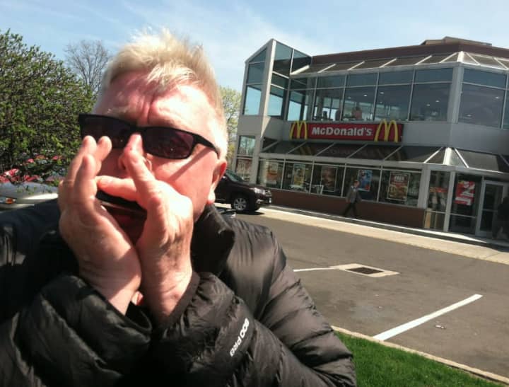 Stamford musician Steve Morrell plays a short tune on his harmonica outside the East Main Street McDonald&#x27;s restaurant in Stamford. He welcomes the updating of Ronald McDonald&#x27;s wardrobe for the chain&#x27;s clown mascot.