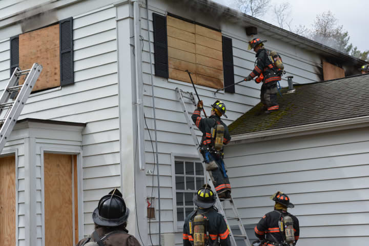 Firefighters practice at a New Castle home.