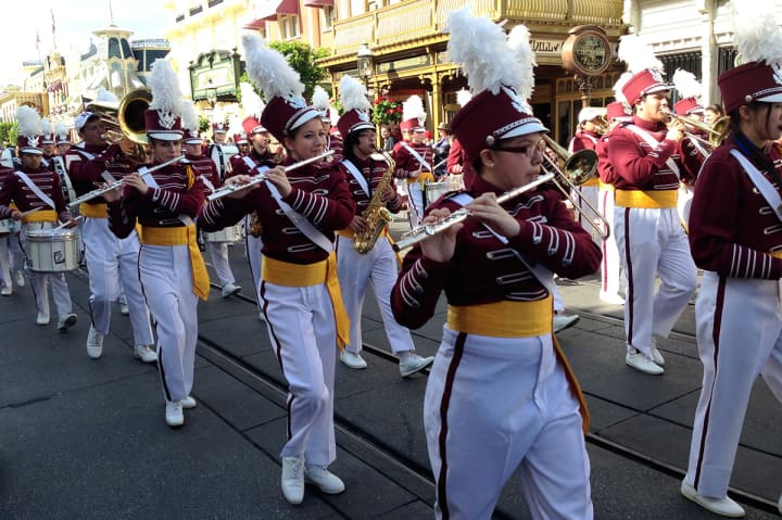 Members of the Harrison High School marching band perform on Main Street USA in Disney World.