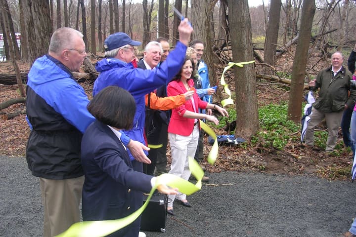 Officials cut the ribbon for the grand opening of the demo trail of the Norwalk River Valley Trail Saturday in Wilton.