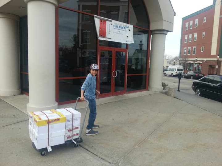Coby Kilion brings to the post office books that will eventually be shipped to Ghana.