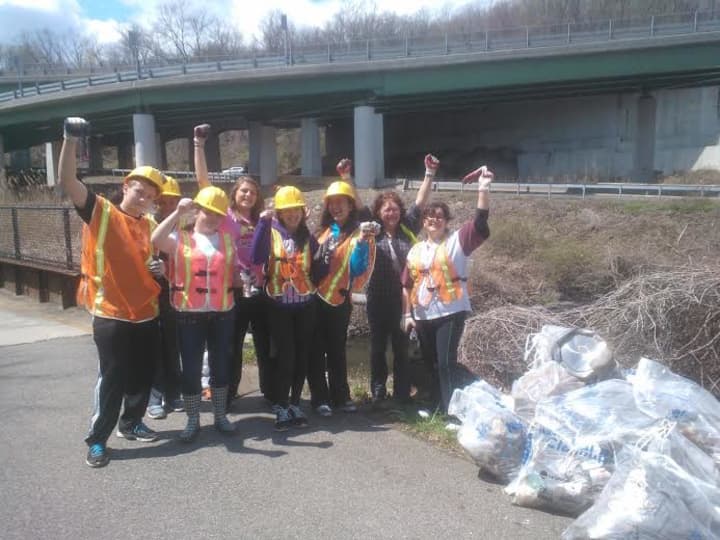Frances McFarland and Any Hudak, among others, work to clean up the Saw Mill River.