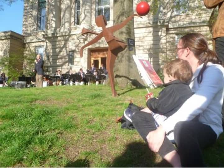 Residents relax on the grass and listen to the Greenwich High Jazz Band during Art to the Avenue in 2011.