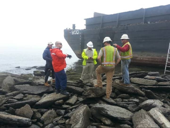 A barge escaped its mooring in Stamford on Wednesday morning and ran aground in Old Greenwich. No one was on board and there was no damage. Officials hope to float it off the rocks either late Thursday or Friday afternoon.