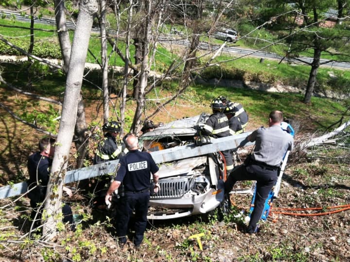 Fairfield police, State Police and Fairfield firefighters work at the I-95 Exit 22 extrication Wednesday morning. 
