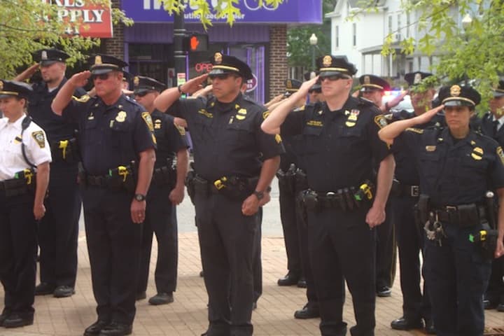 Officers of the Norwalk Police Department salute in honor of those who have died in the line of duty.