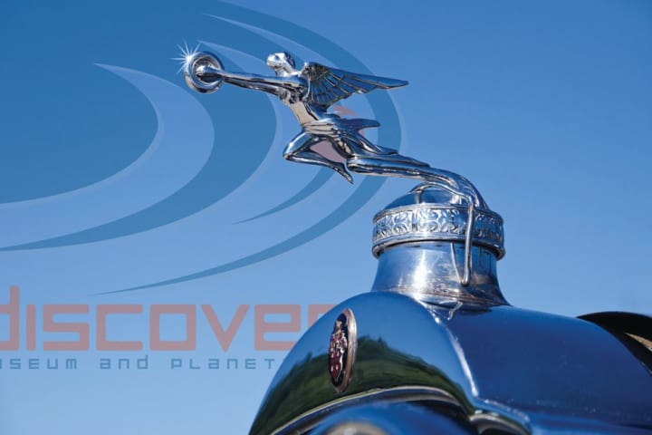 The hood ornament of a classic Packard automobile salutes Discovery Museums gala fundraiser The Science of Luxury: From Stars to Cars will be held on May 17 at Dragone Classic Motorcars in Westport,.