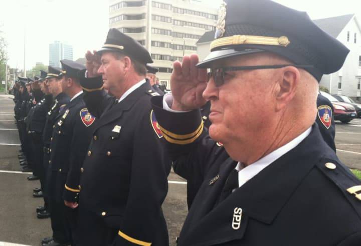 Stamford Police Capt. Bill Mullin, at right, and Capt. Brian McElligott, beside Mullin, salute during an annual memorial service for Stamford Police Officers who died while on duty.