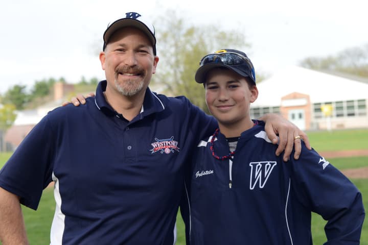 David Goldstein and his son George on the Westport baseball field.