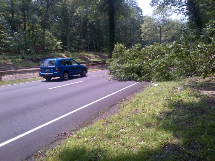 A fallen tree blocks a lane of the Merritt Parkway in Norwalk.