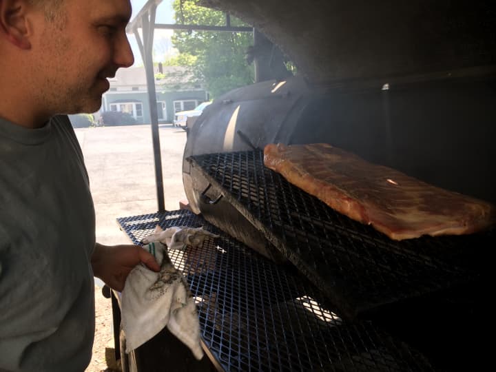 Gino Marsili, owner of the Wire Mill BBQ restaurant in Redding, smokes the bacon he serves on one of the two reverse flow wood smokers that are behind the restaurant.