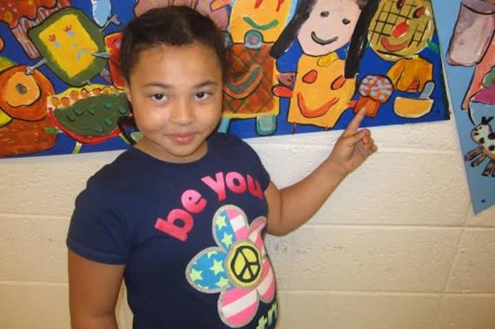 A third-grade student from Highview Elementary School in Greenburgh shows her mural. 