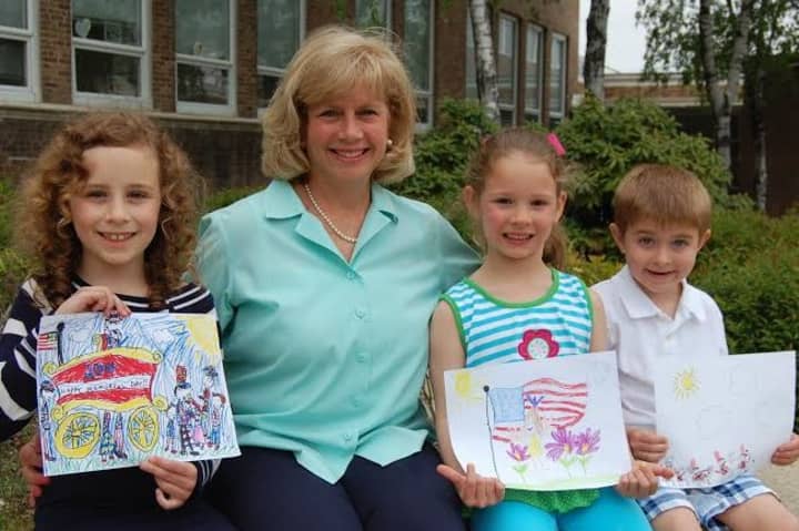 Winners of the second annual Memorial Day Parade Childrens Drawing Contest showcase their artwork. From left are Alexandra Martin, Selectman Susan Marks, Caroline Gies and Ian Schneeberger.

