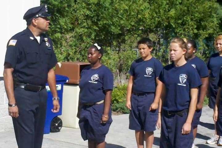 Greenburgh Police Officer David Zenon, a Summer Youth Camp instructor. put his cadets through their paces at the 2013 graduation
