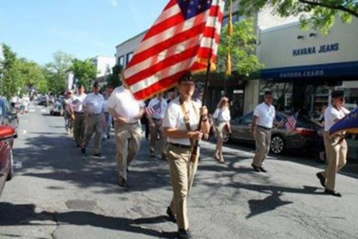 Pictured carrying the flag is Rye resident and Vietnam veteran Fred de Barros.