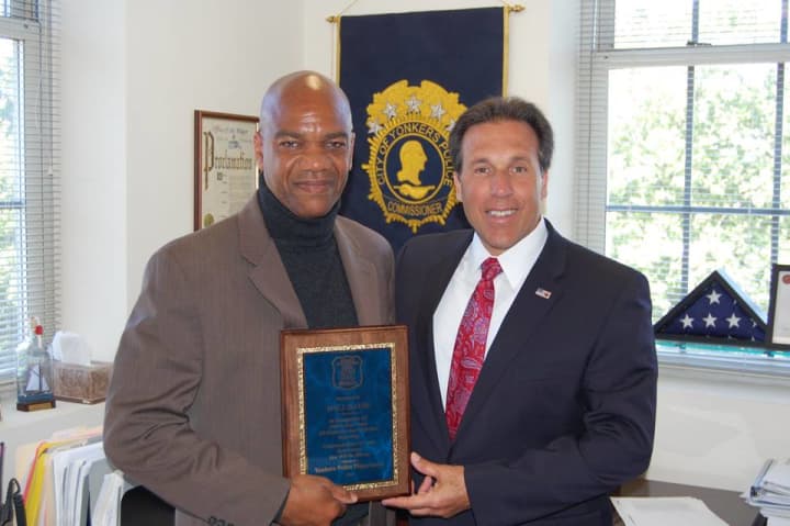 Police Commissioner Charles Gardner, right, presents a plaque to reporter Will David, who is retiring after 32 years.