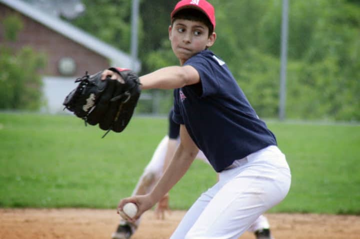 Christopher Cunningham pitches for the Norwalk Extreme 13-year-old team in a game last weekend. Norwalk went 3-1 to take the top spot in pool play of a tournament and advances to this weekend&#x27;s championship round in New York.