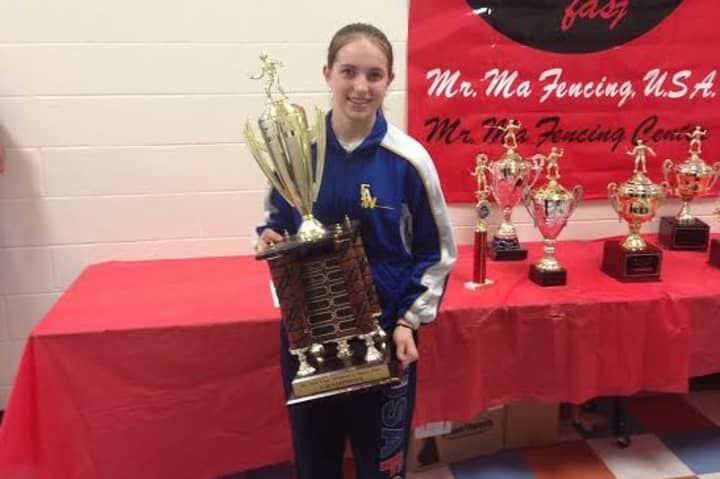 Sylvie Binder (14) holds the first place award for winning the 2014 Womens Senior Open Foil competition at the Mr. Ma Cup. 