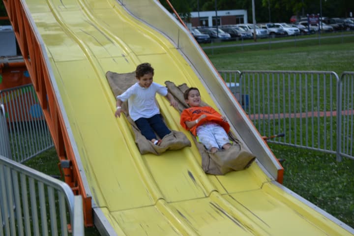 6-year-old Sam Zdanoff (left) and 7-year-old Octavio Esposito (right) on a slide at the Fol de Rol.
