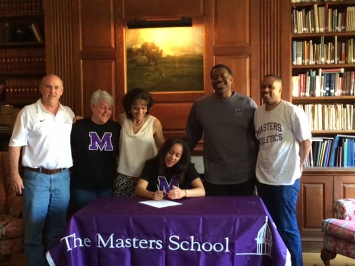 Masters School senior Naya Williams is joined by Athletic Director Kevin Versen, head coach Warren Bunkley and family as she signs her letter of intent. 