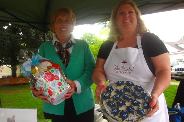Nancy Saxe of Sweet Pierre&#x27;s and Susan Schmitt of the Painted Cookie offer some of their sweets to the attendees of a Taste of Wilton on Monday.