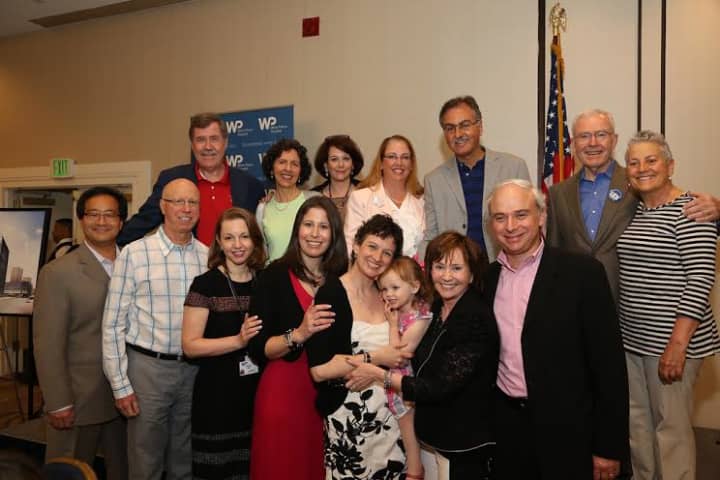 Rebecca Schmidt poses with members of the White Plains Hospital leadership and medical team who cared for her at their 2014 Cancer Survivors Day celebration at the Crowne Plaza Hotel.