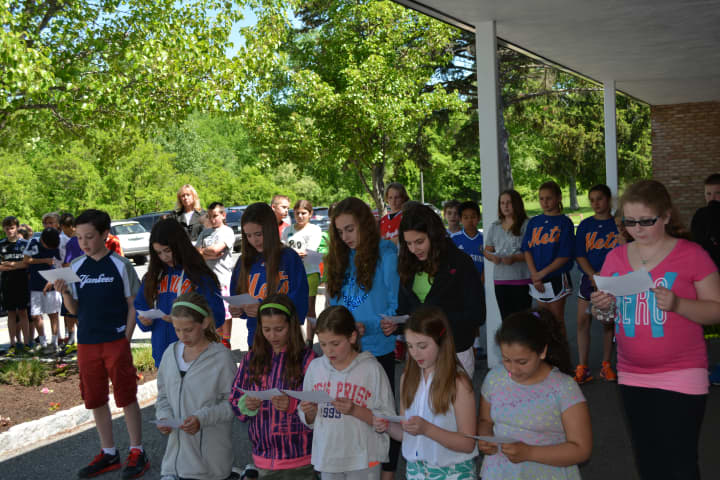 Groups of Increase Miller students read poetry as part of the school&#x27;s 50th anniversary celebration.