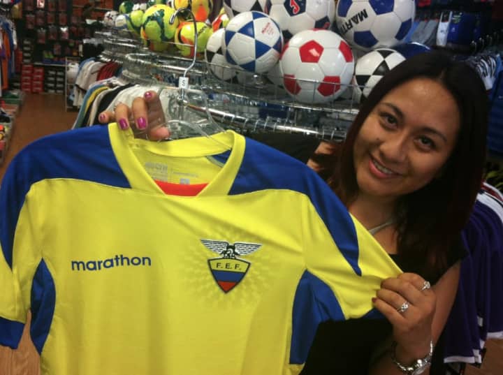 Mayria Tepan, of Port Chester, N.Y., holds the jersey of Ecuador, her native country, while in Soccer Land in Stamford on Wednesday. The World Cup begins Thursday, and Ecuador is one of the countries taking part. 