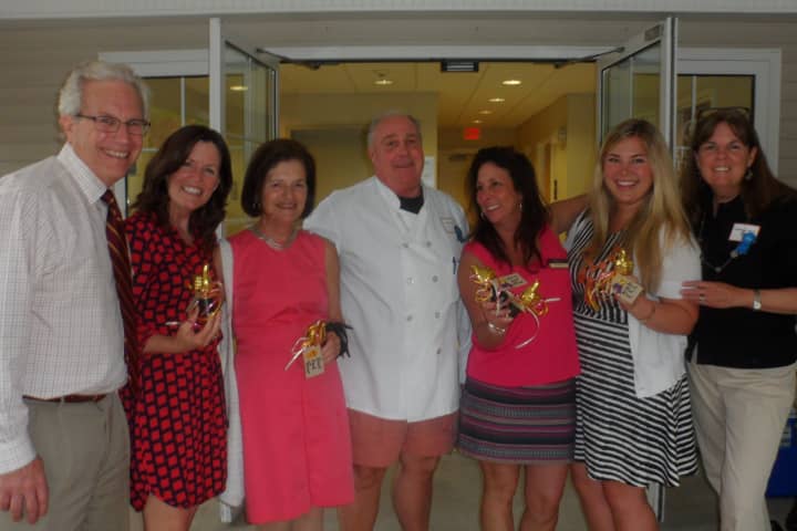 Winners and judges from a bake off at Summer Kickoff Porch Party hosted by Berkshire Hathaway HomeServices New England Properties of Darien meet at the party. 