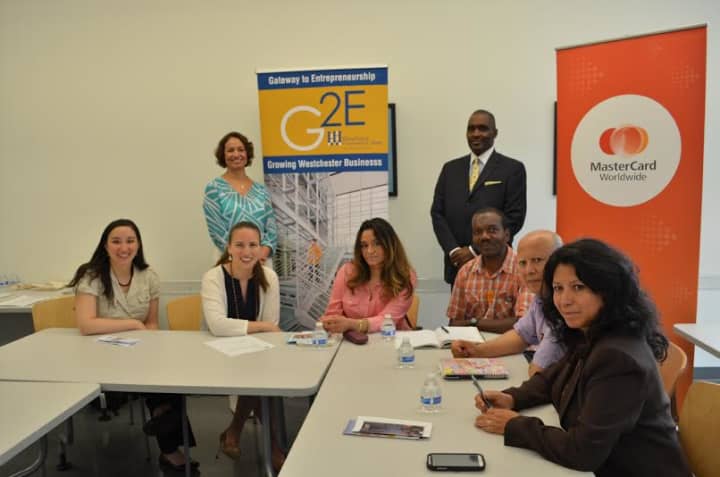 Eridania Camacho, director, Gateway to Entrepreneurship and WCC professor Scorpio Rodgers, (standing), are joined by MasterCards Elizabeth Liu, program manager, and Monica Chaves, senior program officer, Global Partnership, left.