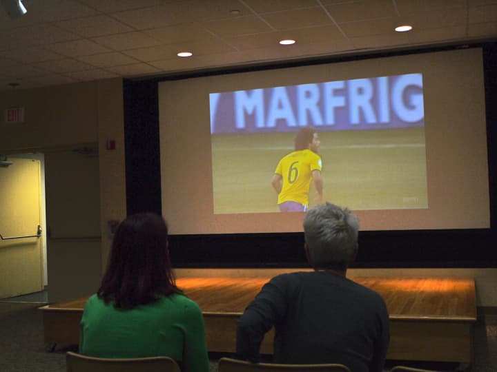 Westport residents Barbara Powell and Patricia Bello watch the first match of the World Cup tournament, cheering on Brazil in the McManus Room at the Westport library. 