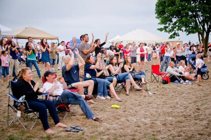 Folks enjoy a free summer concert at Calf Pasture Beach. 