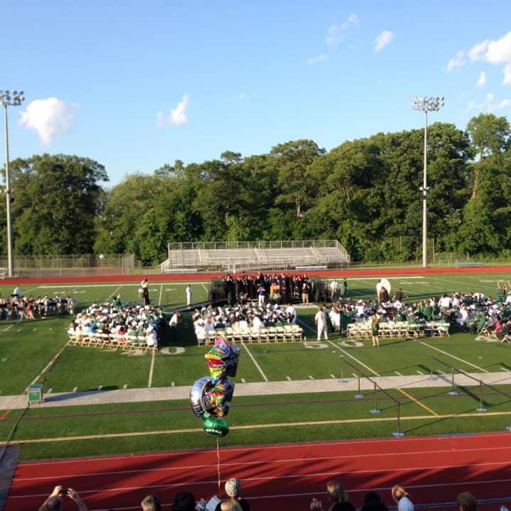 The Class of 2014 begins to line up for graduation on the football field at Norwalk High School. 