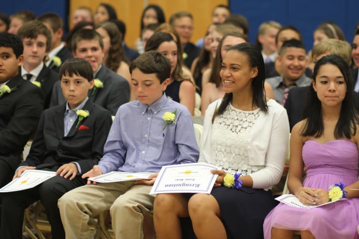 A student smiles at her family after her row received their certificates.