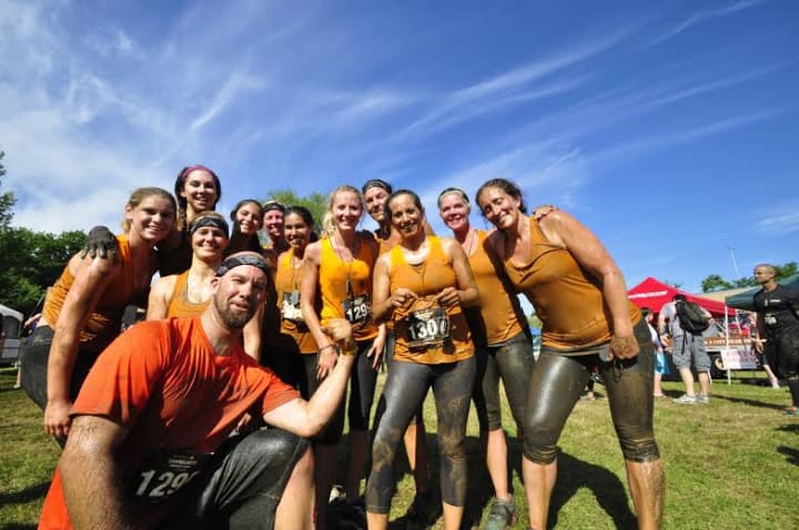Team Sherpa from Westport celebrates after completing the Down &amp; Dirty obstacle race in Hartford. 