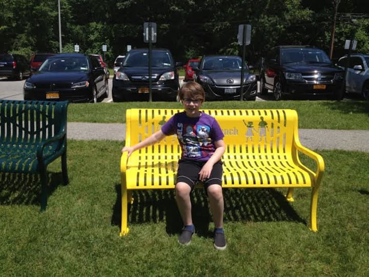 Hastings&#x27; Ben Johnson sits on the &quot;Buddy Bench&quot; he helped bring to his Hillside School campus.
